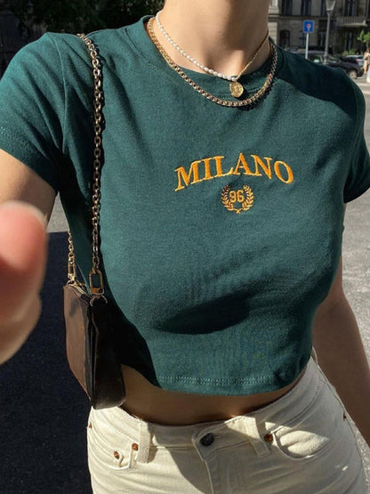 A Classy Chic Boutique forest green crop top with gold embroidered Milano 96 graphic and crew neckline.