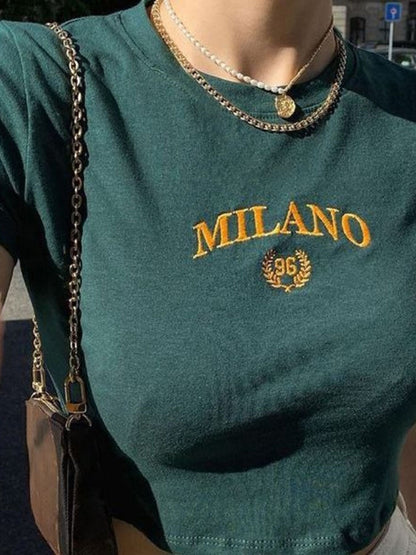 A Classy Chic Boutique forest green crop top with gold embroidered Milano 96 graphic and crew neckline.